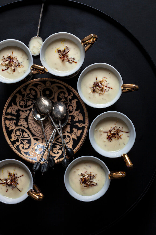 Cups of doodh pak, Gujarati rice pudding, topped with saffron and nuts