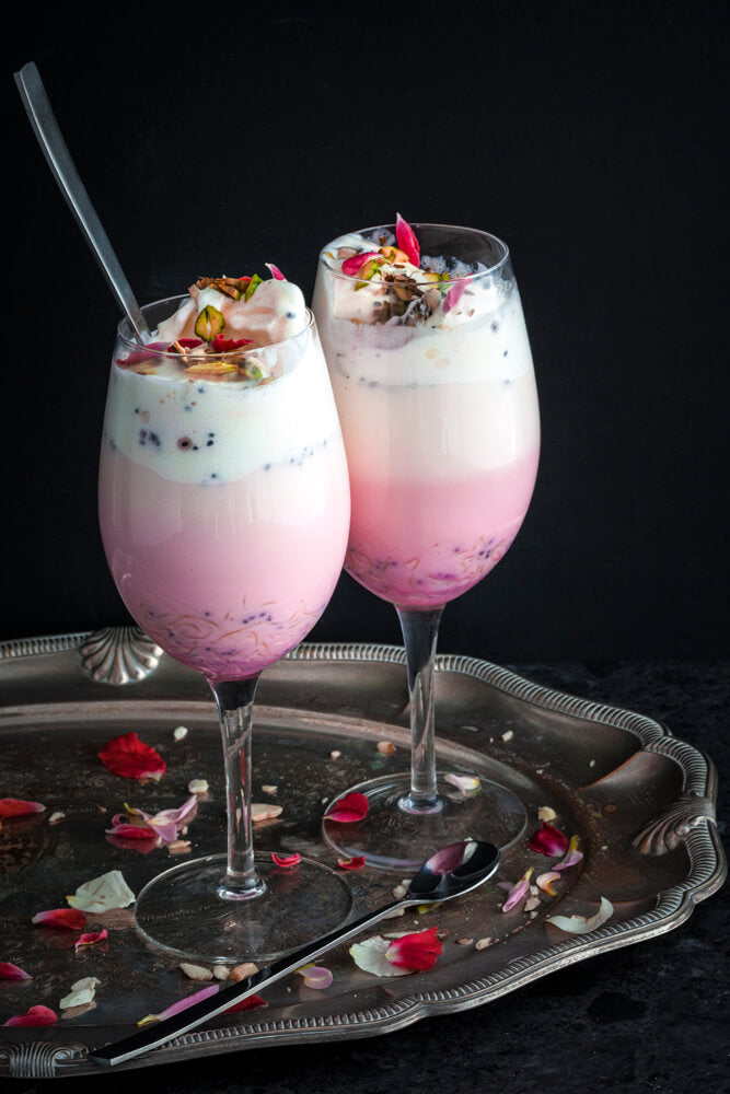 Two glasses of rose falooda on a silver tray