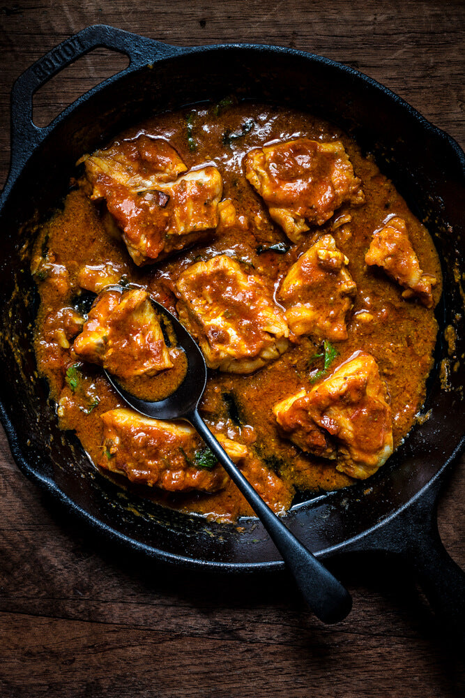 Gujarati fish curry in a cast iron pan