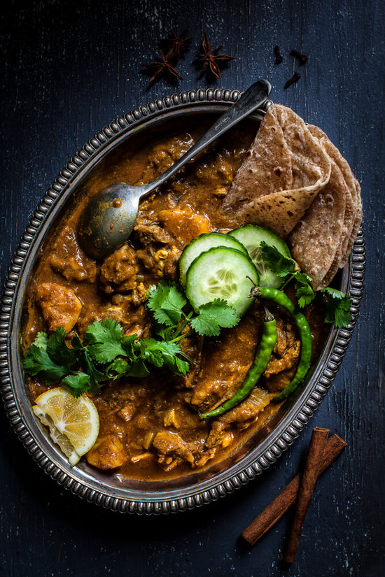 Lamb Curry, Gujarati Gorse with rotli, fresh coriander, lemon and cucumber