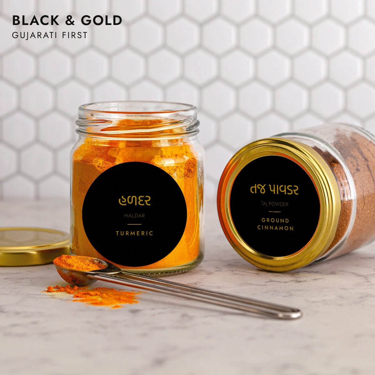 Round black and gold Gujarati pantry labels on jars, Gujarati script first