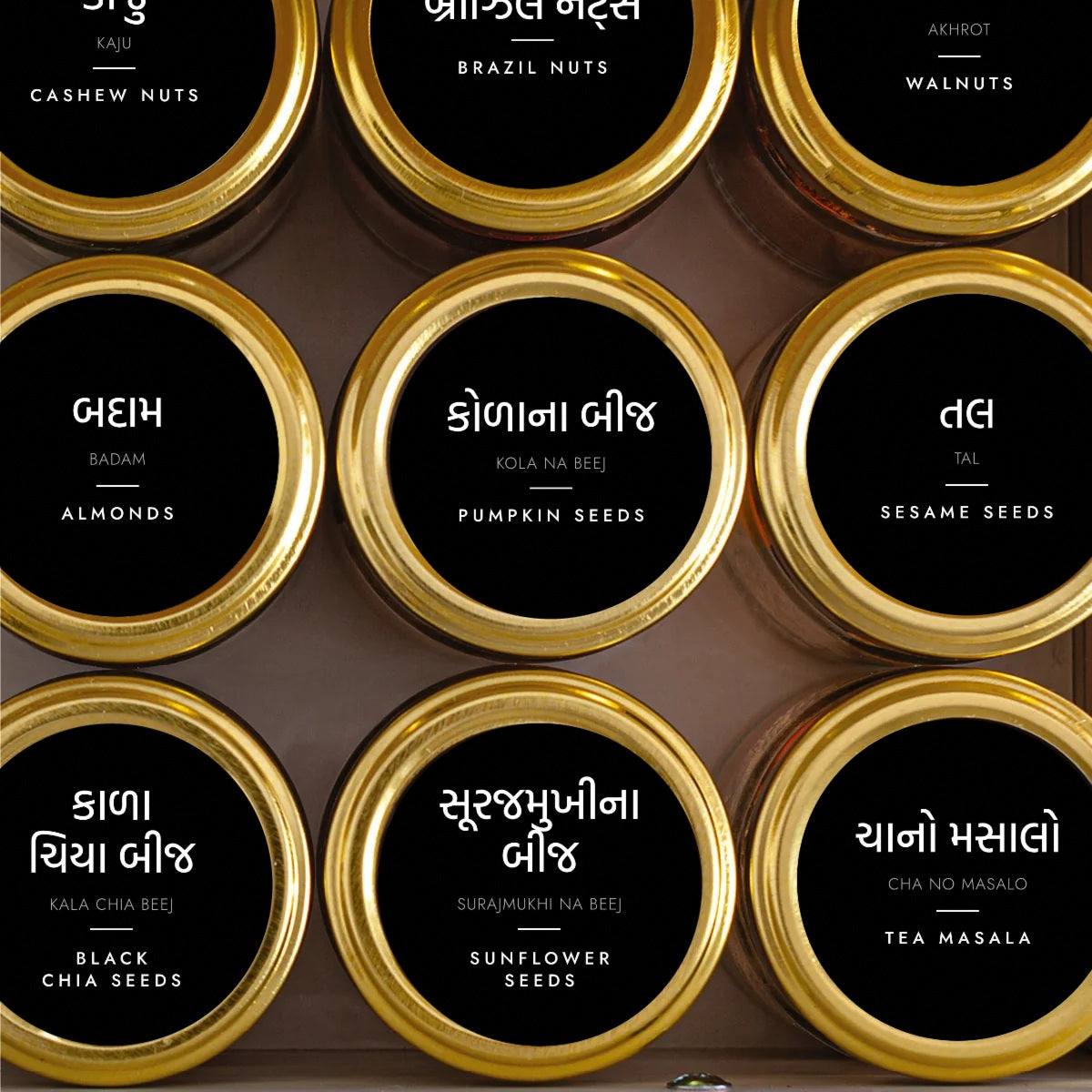 Round black and white Gujarati pantry labels on jars, Gujarati script first